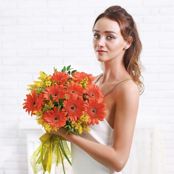 Gerbera daisies - 9, Solidago (1 pc.), Pistachio, Mesh (Abaka), Ribbon