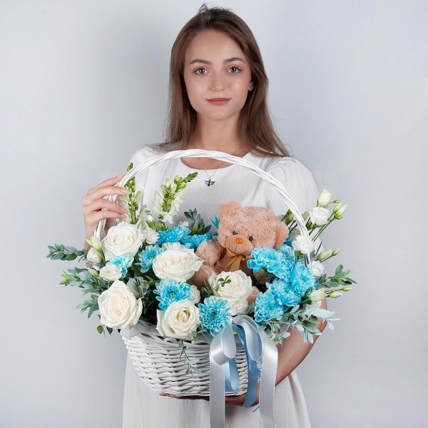 White Matthiola - 2, White rose 50 cm - 9, Chrysanthemum spray Baltica painted blue - 3, White spray carnation - 4, lisianthus - 3, Medium Basket, Oasis, Pistachio, Teddy bear 20 cm, Ribbon