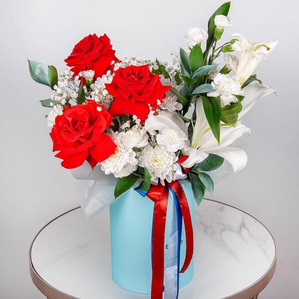 Red rose Nina 50 cm - 3, Gypsophila - 1, Baltica White Spray Chrysanthemum - 1, White spray carnation - 3, Carnation white, cream - 1, Lilies - 1, Round flower box medium, Oasis, Ruscus, Ribbon