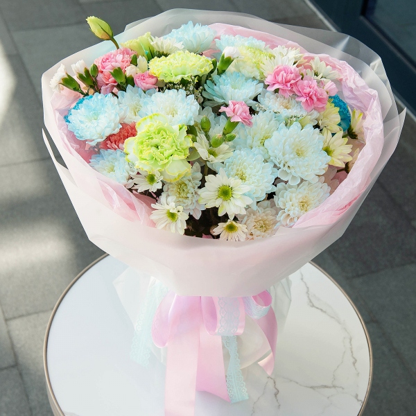 Chrysanthemum spray Baltica painted blue - 4, Pink carnation - 6, Carnation white, cream - 10, Bacardi Yellow Spray Chrysanthemum - 4, Pink spray carnation - 9, Limonium (1 pc.), Wrapping Paper