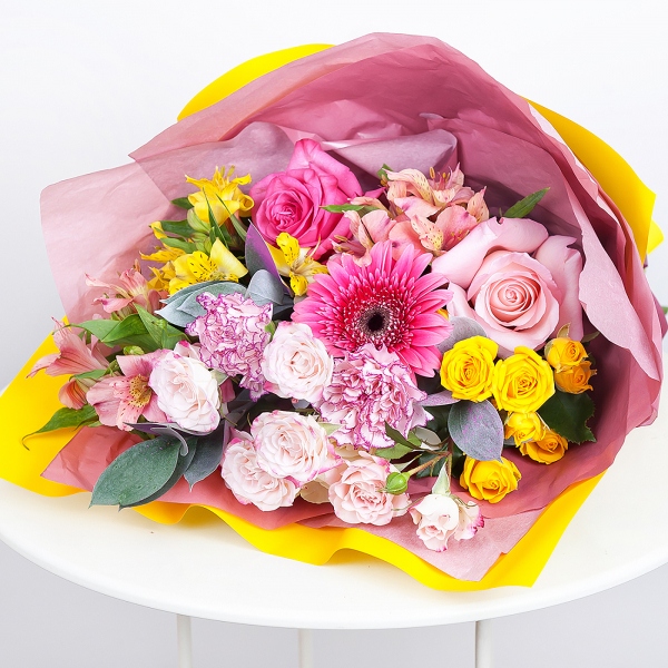 Gerbera pink - 2, Alstromeria white, soft pink - 2, Pink carnation - 3, Spray rose: yellow, orange 50 cm - 2, Pink rose 50 cm - 3, Alstromeria Yellow, Orange - 1, Spray rose: white, cream, light pink 50 cm - 1, Ruscus, Wrapping Paper