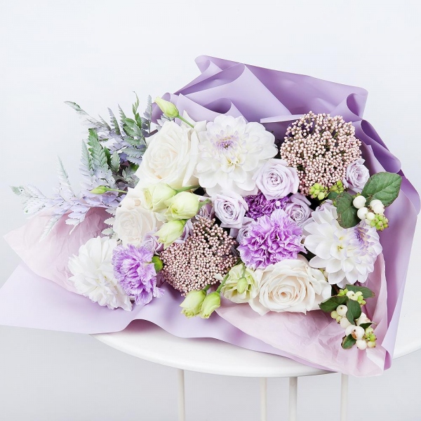 White rose 50 cm - 5, White Dahlia - 3, Lilac carnation - 5, Spray rose: white, cream, light pink 50 cm - 2, lisianthus - 2, Ozotamnus, Fern (1 pc.), Symphoricarpos, Wrapping Paper