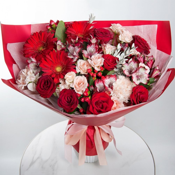 Gerbera red - 3, Red rose 50 cm - 11, Spray rose: white, cream, light pink 50 cm - 5, Alstromeria Red, Bright Pink - 7, Carnation white, cream - 7, Hypericum, Pistachio, Wrapping Paper