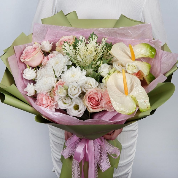 White cut anthurium - 2, lisianthus - 2, Pink carnation - 3, Pink rose 50 cm - 5, Baltica White Spray Chrysanthemum - 2, Wrapping Paper, Brassica