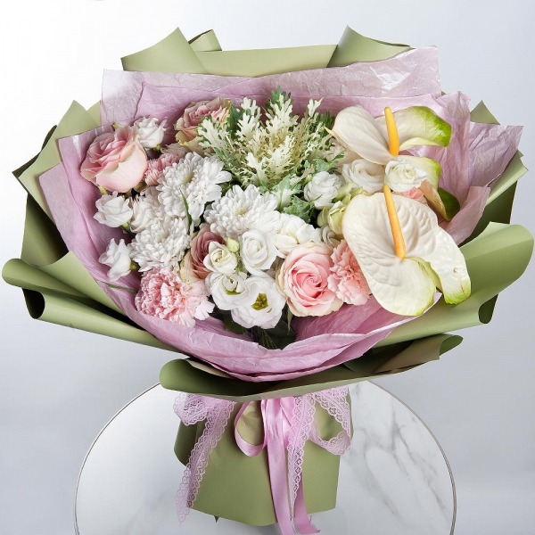White cut anthurium - 2, lisianthus - 2, Pink carnation - 3, Pink rose 50 cm - 5, Baltica White Spray Chrysanthemum - 2, Wrapping Paper, Brassica