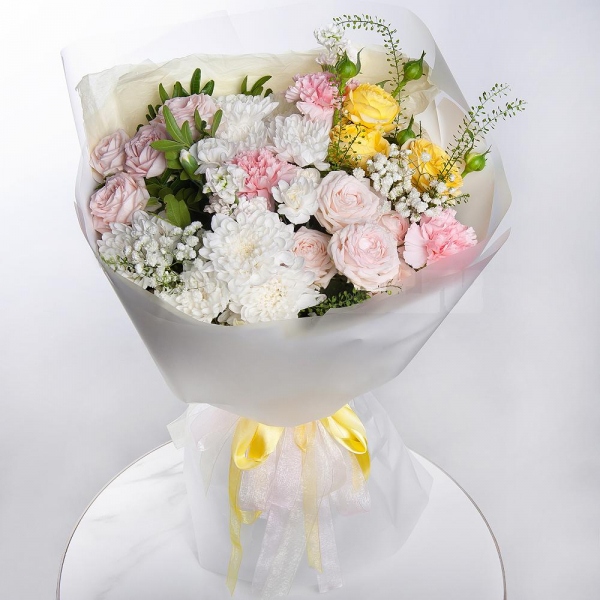 Baltica White Spray Chrysanthemum - 2, Peony sprayrose - 2, Pink carnation - 7, White spray carnation - 2, White Matthiola - 2, Gypsophila - 1, Spray rose: yellow, orange 50 cm - 1, Pistachio, Green bell (1 pc.), Wrapping Paper