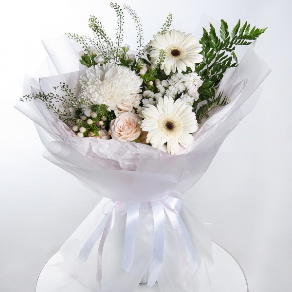 Gerbera white - 4, Magnum White Chrysanthemum - 1, Peony sprayrose - 2, White spray carnation - 3, White Matthiola - 2, Hypericum, White statice, Pistachio, Fern (1 pc.), Green bell (1 pc.), Wrapping Paper